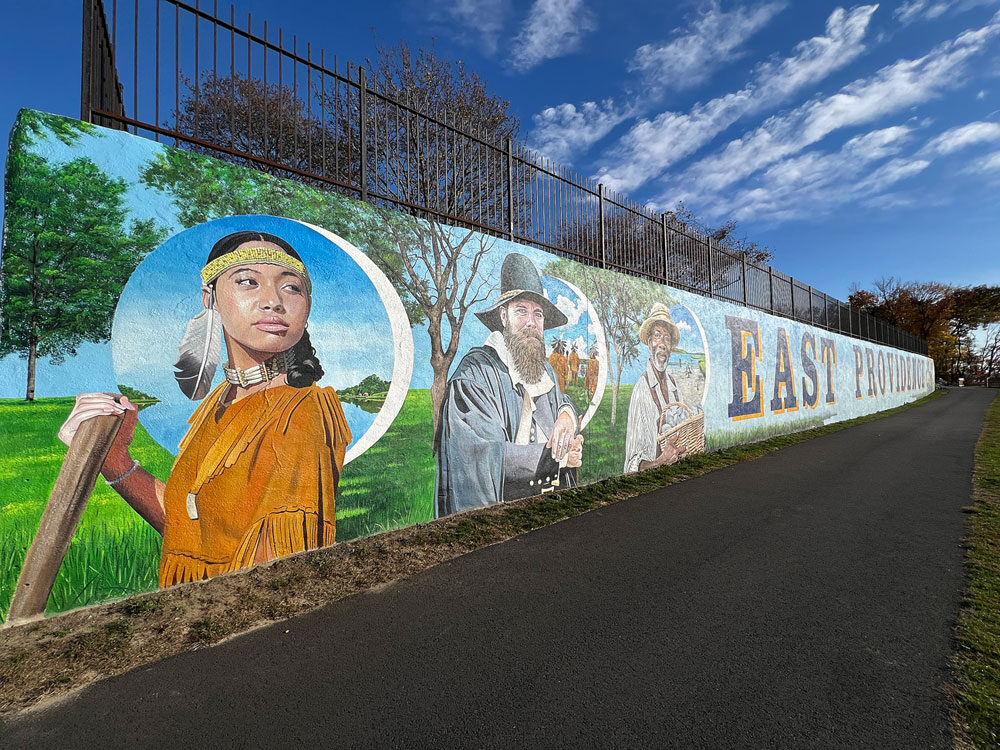 Explore the rich history and vibrant future of East Providence through a stunning 200-foot mural on the Crescent Park Beachfront Wall. Featuring Native heritage, local landmarks, and iconic symbols, this artwork celebrates the city’s cultural resilience and scenic beauty