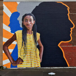 Fearless Girl Mural painted on the exterior of Beacon Charter High School in Woonsocket, RI by Charles C. Clear III and Bonnie Lee Turner